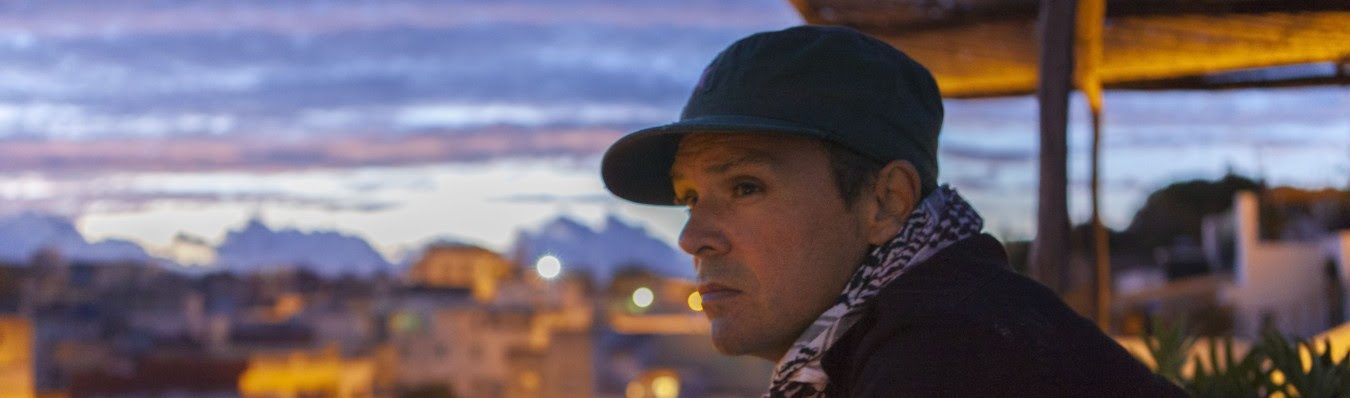 alex henry foster looking over a city at dusk
